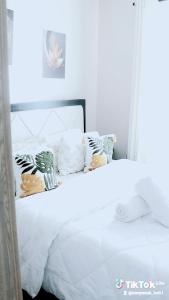 a white bed with white sheets and pillows at Purity homes ruiru in Ruiru