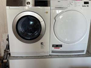 a washing machine and a dryer sitting on a shelf at Villa Margot in Schrems
