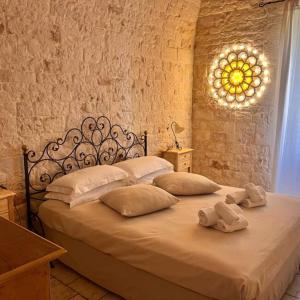 a bedroom with a bed with towels on it at Relais Masseria Serritella in Castellana Grotte +53 photos