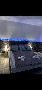 a large bed with two towels on top of it at Willow Apartmant in Harkány