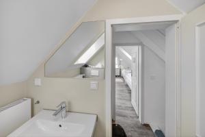 a bathroom with a sink and a mirror at Gurtdeel 1000 Sterne-Suite in Hörnum