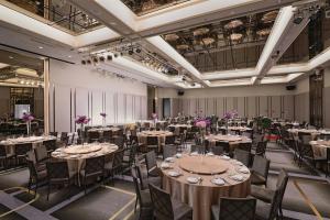 a banquet hall with tables and chairs in a room at Taipei Marriott Hotel in Taipei