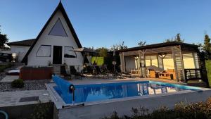 a house with a swimming pool in front of a building at Laganini house Vinča in Belgrade