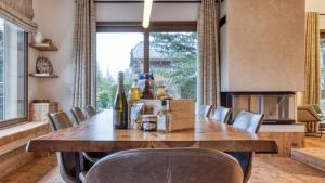a dining room with a large wooden table and chairs at Chalet Le Savoy in Chamonix