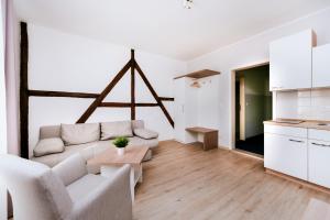 a white living room with a couch and a table at Hotel zur Seemöwe in Insel Poel +7 photos
