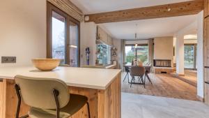 a kitchen and living room with a counter and chairs at Chalet Le Savoy in Chamonix