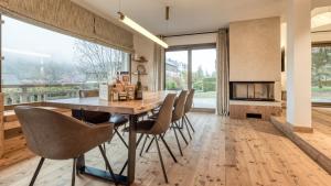 a dining room with a table and chairs and a fireplace at Chalet Le Savoy in Chamonix