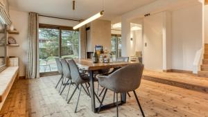 a kitchen and dining room with a wooden table and chairs at Chalet Le Savoy in Chamonix