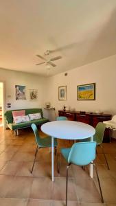 a living room with a table and chairs and a couch at Casa Angela in Toscolano Maderno