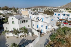 an aerial view of a white house at Hotel Pleasure Blackbeach Santorini in Perissa
