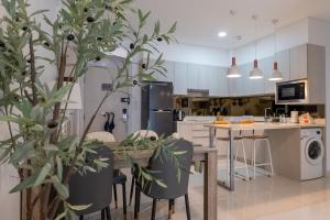 a kitchen with a table and some plants at Cassia Residence by Metrika, Laguna Phuket in Laguna Phuket