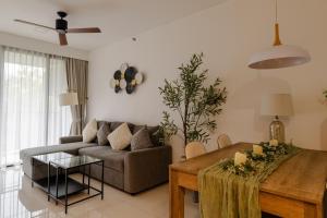 a living room with a couch and a table at Cassia Residence by Metrika, Laguna Phuket in Laguna Phuket