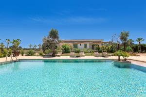 a swimming pool in front of a house at Agriturismo Li Frutti in Otranto