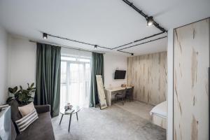 a living room with a bed and a desk in a room at Aparthotel "Mayak Yablunytsia" in Yablunytsya