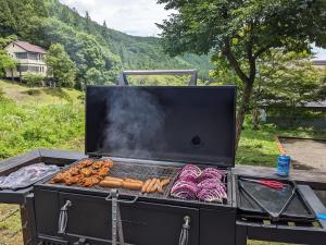 a grill with a bunch of food on it at Tanigawa Valley Lodge & Coffee Roastery in Minakami