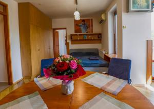 a table with a vase of flowers on top of it at Balaton Vista in Balatonfüred