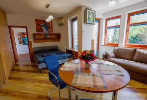 a living room with a table and a couch at Balaton Vista in Balatonfüred