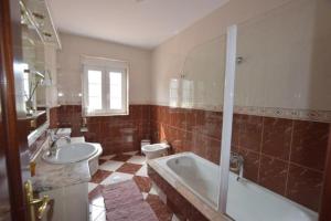 a bathroom with a tub and a toilet and a sink at Casa Emiliano in Cee +30 photos