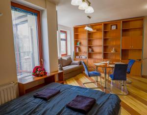 a bedroom with a bed and a table and a couch at Balaton Vista in Balatonfüred +4 photos