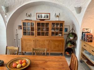 a dining room with a table and a wooden cabinet at Wohnhaus am Marktplatz in Röhrnbach in Röhrnbach