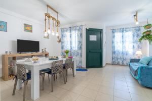 a living room with a table and chairs and a couch at La Casa Di Chloe in Marzamemi