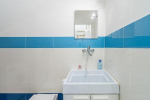 a bathroom with a white sink and a mirror at La Casa Di Chloe in Marzamemi +21 photos
