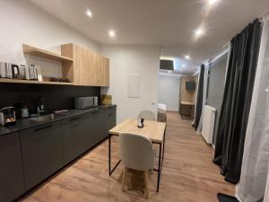 a kitchen with a table and chairs in a room at Apartmenthaus Zeuthen 3 in Zeuthen