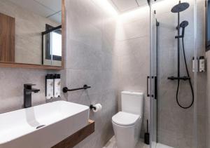 a bathroom with a shower and a toilet and a sink at Nommadas Cotty - Only Adults in Denia