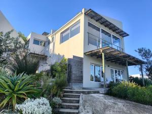 a house with stairs in front of it at Betty in Plettenberg Bay