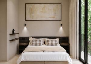 a bedroom with a bed with two pillows on it at Nommadas Cotty - Only Adults in Denia +6 photos