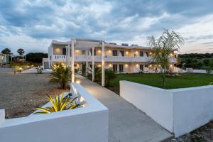 a large white building with lights in front of it at SolMare Premium Suites in Mastihari +41 photos