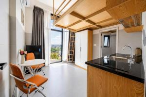 a kitchen with a sink and a table with chairs at Savia Home in Danang
