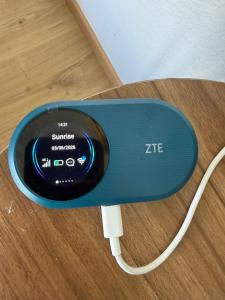 a blue stimulator with a cord attached to a table at Studio chic et élégant avec Wi-Fi et Smart TV in Lausanne