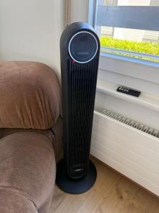 a heater sitting next to a chair next to a window at Studio chic et élégant avec Wi-Fi et Smart TV in Lausanne +1 photo