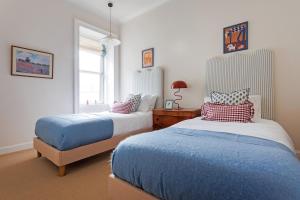a bedroom with two beds and a window at The Greenhouse Ayr in Ayr