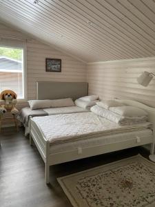 a bedroom with two beds in a room at Villa Rönnholm in Kristinestad
