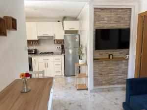 a kitchen with a stainless steel refrigerator and a counter at Armonia buglaow residence MARSA MDIQ in M'diq