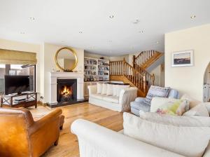 a living room with two couches and a fireplace at Calla Lookout in Roundstone