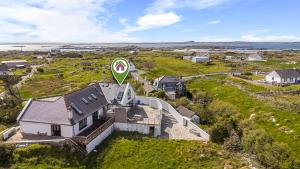 an aerial view of a house with a road sign on it at Calla Lookout in Roundstone
