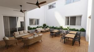 a living room with tables and chairs and a patio at Nommadas Cotty - Only Adults in Denia