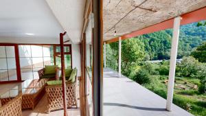 a room with a balcony with a view at Relocation Dili House in Dilijan