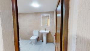 a bathroom with a toilet and a sink at Relocation Dili House in Dilijan +13 photos