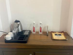 a counter with a coffee maker and two bottles on it at Hotel Pratap Palace in Bharatpur