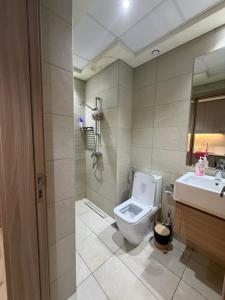a bathroom with a toilet and a sink at Azizi Riviera in Dubai