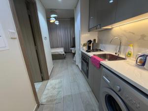a kitchen with a sink and a dishwasher at Azizi Riviera in Dubai