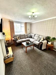 a living room with a couch and a coffee table at The Alexandria in Westhoughton