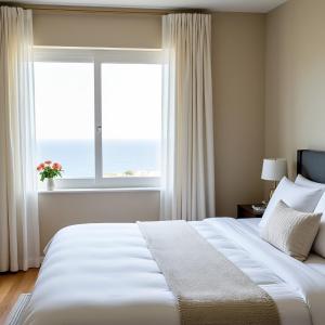 a bedroom with a large white bed and a window at Convince in Larnaca