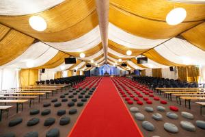 a large room with chairs and a red carpet at Shree Peetha Nilaya - Hindu Ashram in Springen