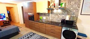 a kitchen with a washer and dryer in a room at Sesimbra Sea Apartment with Pool & Gym near Lisbon in Sesimbra