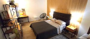 a bedroom with a bed and a table and chairs at Sesimbra Sea Apartment with Pool & Gym near Lisbon in Sesimbra